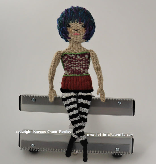 Doll sitting on a Chloe Pocket Loom