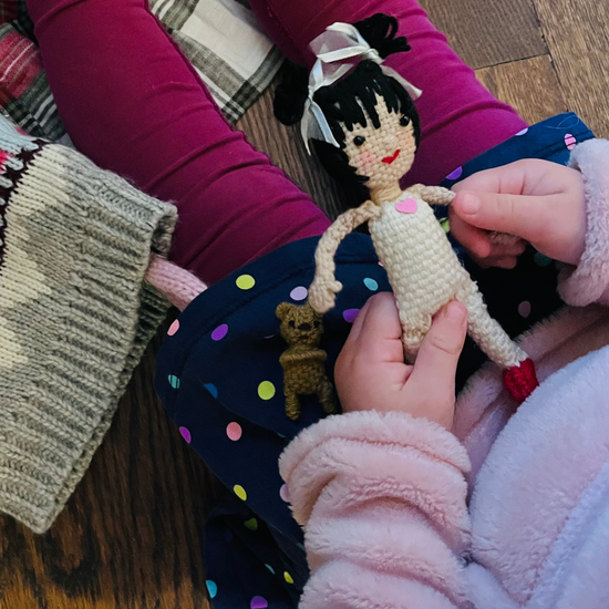 The Lily Doll in child's hand