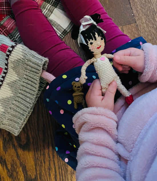 Load image into Gallery viewer, Lily doll being held by a child
